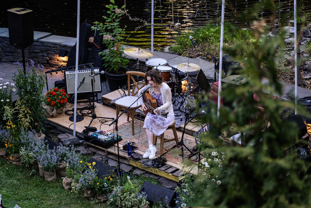 Ginger Winn playing and singing on stage.