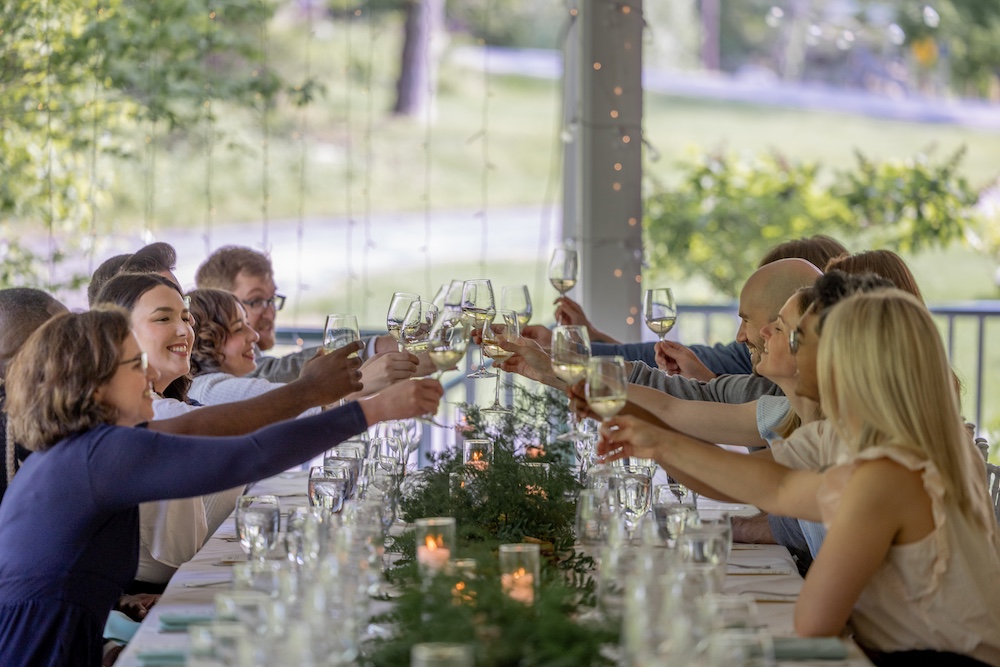 Table of guests toasting atHudson Valley Wine Dinners at Mohonk Mountain House in New Paltz NY.