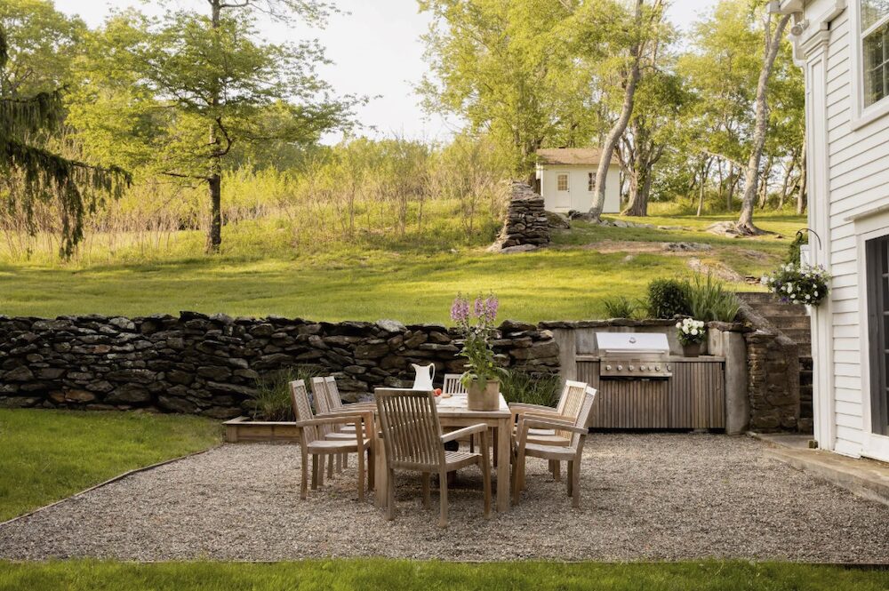 An outdoor grill and table with chairs for dinners at 809 North Quaker Hill Road, Pawling NY.