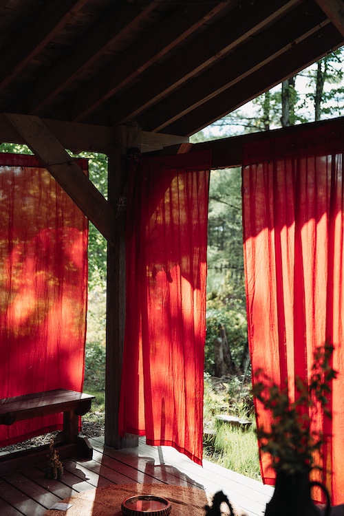 red curtains hanging from beams for the gathering.