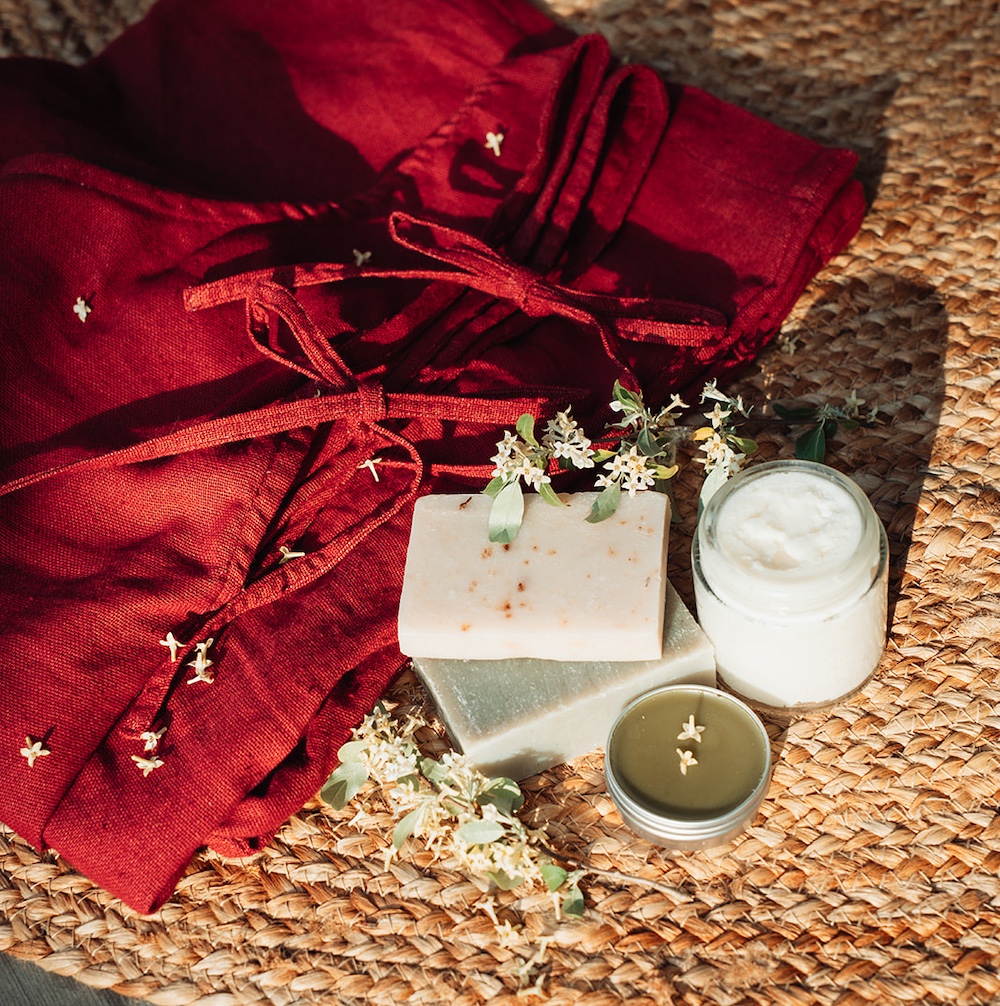 Homemade soap, salve, candles and red clothes.