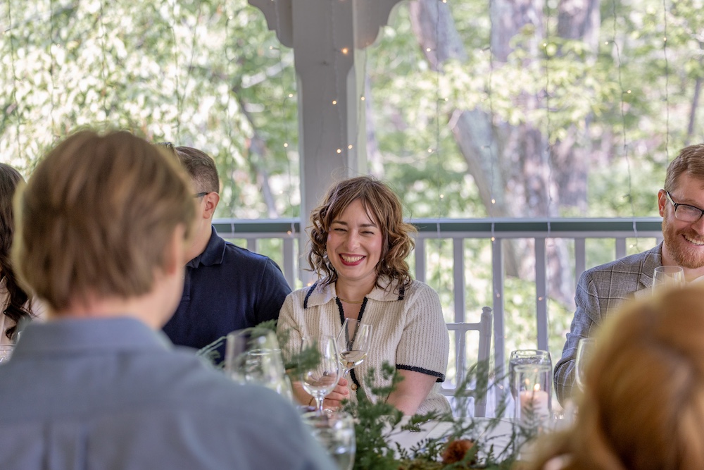 A woman smiling at Hudson Valley Wine Dinners at Mohonk Mountain House in New Paltz NY.