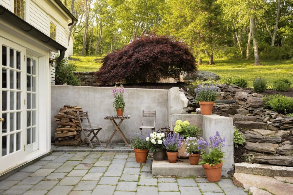 The side door of the house and pation with stone steps at 809 North Quaker Hill Road, Pawling NY.