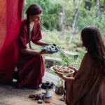 The Red Tent two women sharing food in the tent
