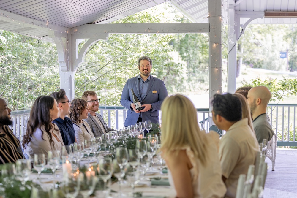 The sommelier is presenting the wine at Hudson Valley Wine Dinners at Mohonk Mountain House in New Paltz NY.