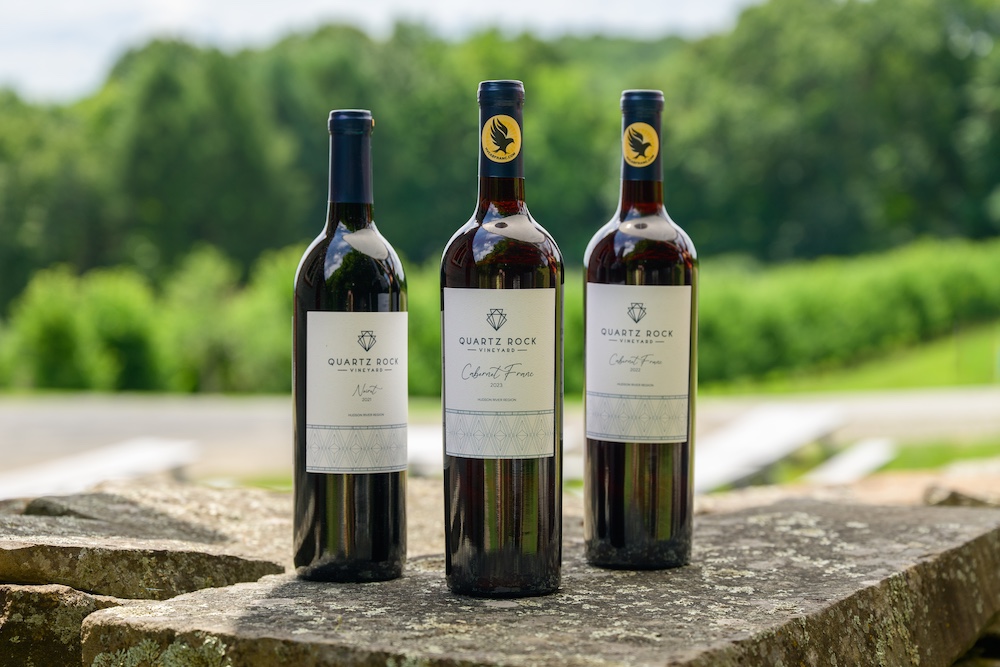 three bottles of award-winning wine on the rocks at Quartz Rock Vineyard & Winery and Cider House in Marlboro NY.