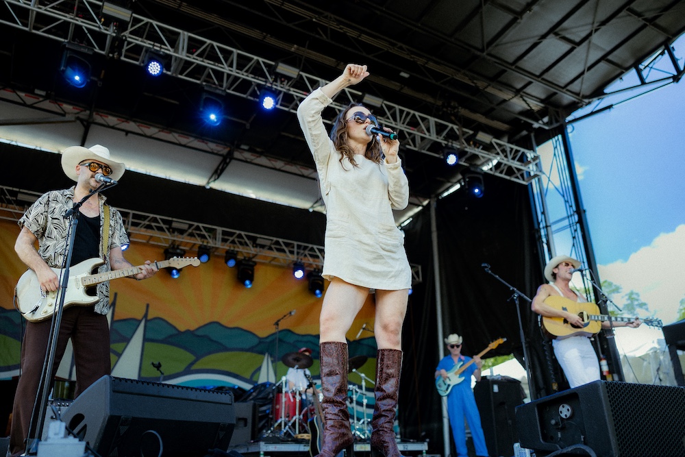 Chaparelle performing on stage at the Hudson River Music Festival in Croton Point Park NY.