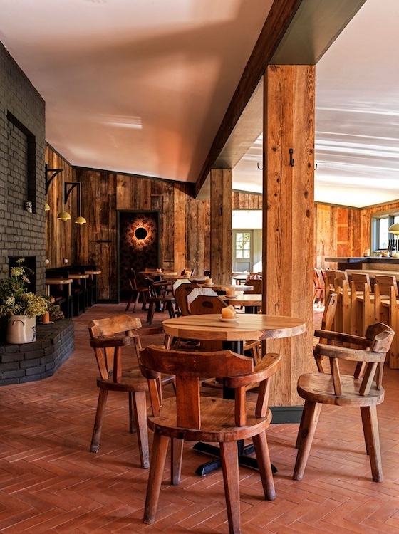 Wooden dining room with tables, chairs and more at Little Cat Lodge in Hillsdale NY.