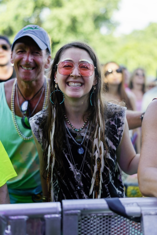 A fan smiling at the camera at the Hudson River Music Festival in Croton Point Park NY.