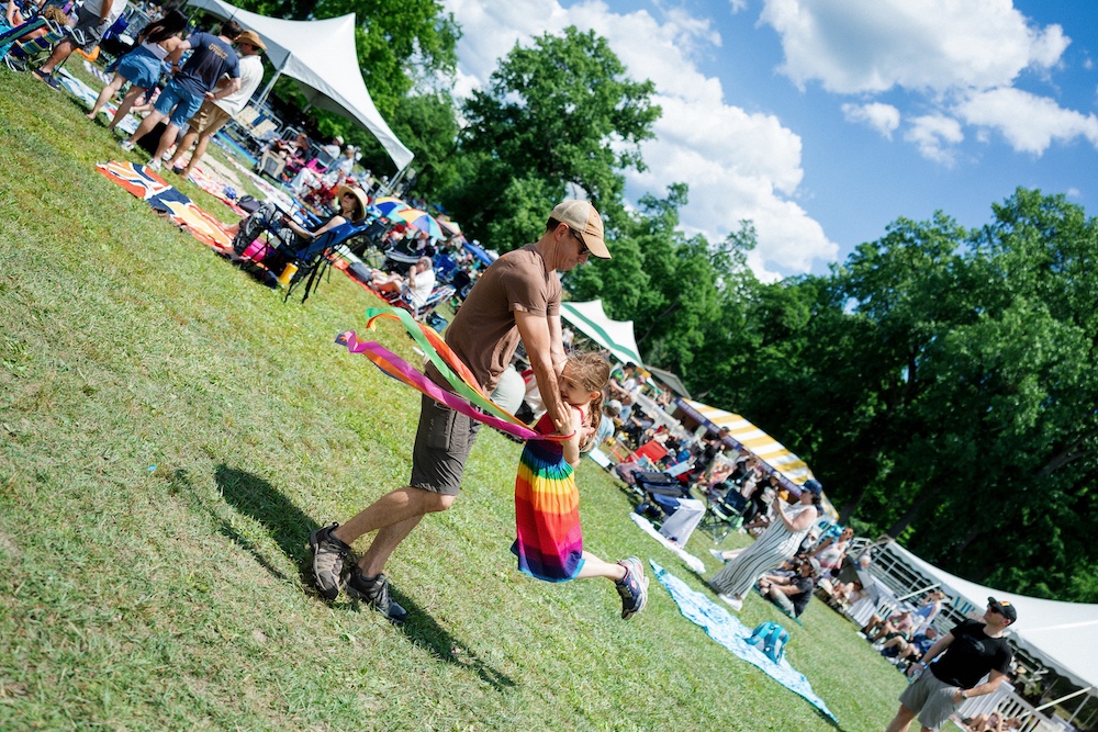 Father's Day fun with swinging his kid at the Hudson River Music Festival in Croton Point Park NY.