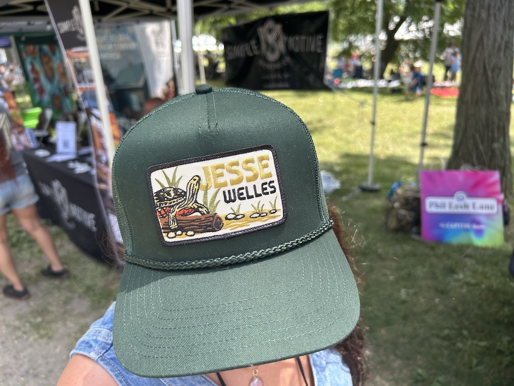 Jesse Welles swag hat at Hudson River Music Festival at Croton Point Park NY.