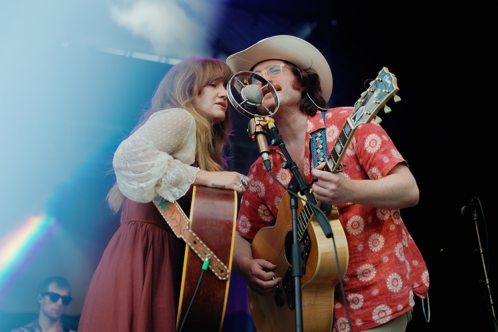 Margo Price singing on stage with her band mate at the Hudson River Music Festival in Croton Point Park NY.