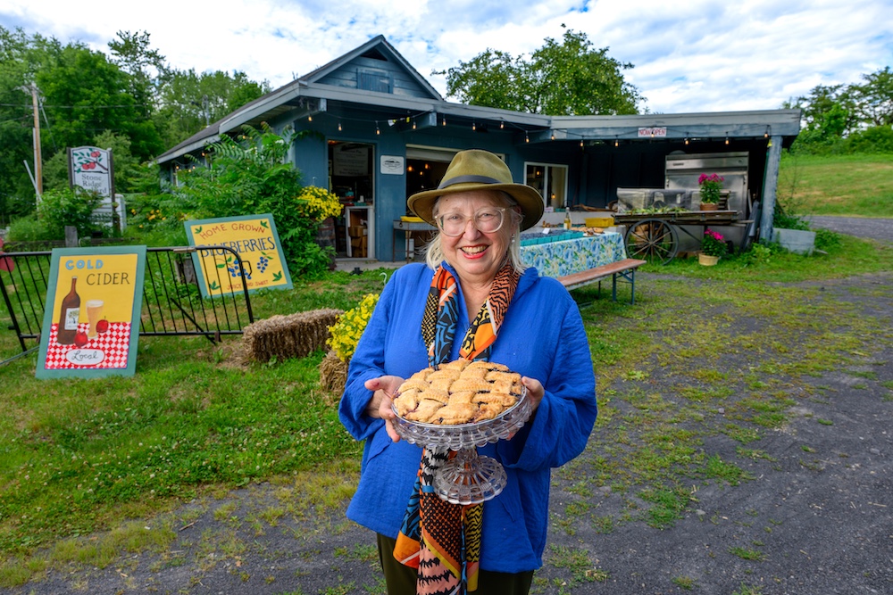 Elizabeth Ryan at Stone Ridge Orchard holding a blueberry pie.