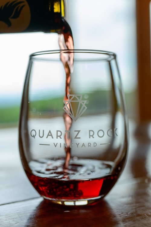 Pouring Cabernet Franc wine into a Quartz Rock Winery glass in their tasting room in Marlboro, NY.