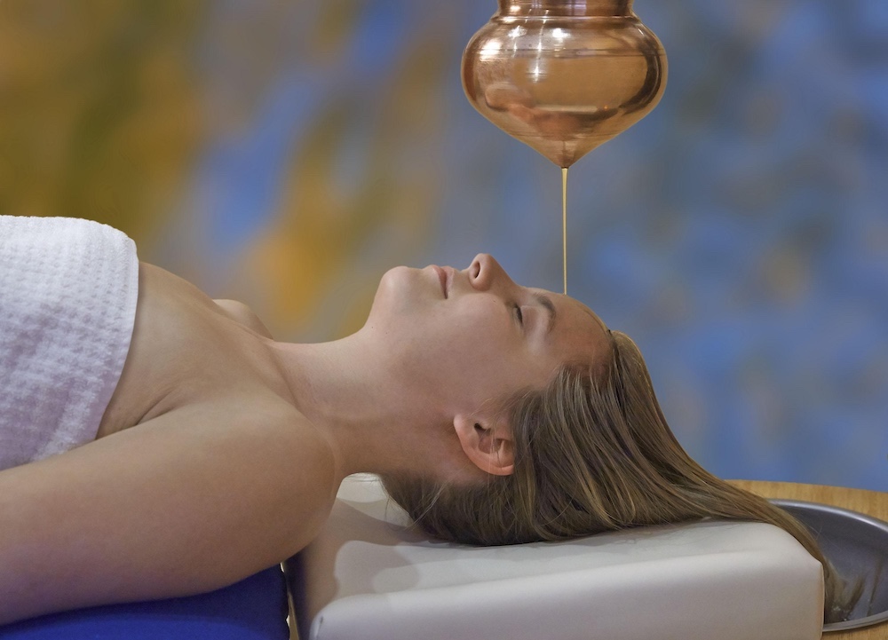 Shirodhara warm oil dripping on your third eye at Menla Retreat & Dewa Spa.
