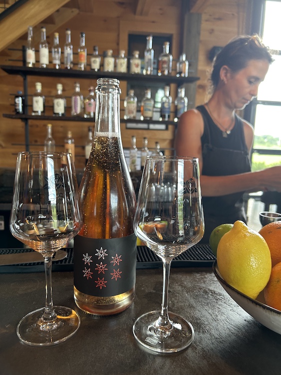 Tasting room bartender and some sparkling spirits.