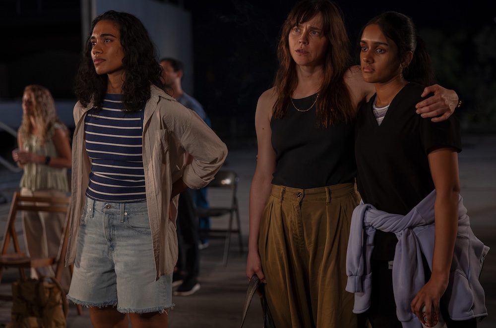 Fiona Dourif and two women in the dark watching something that is making them emotional on the TV show, The Pitt.