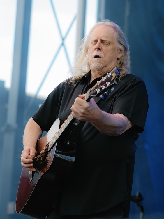 Warren Haynes feeling his guitar while playing at the Hudson River Music Festival in Croton Point Park NY.