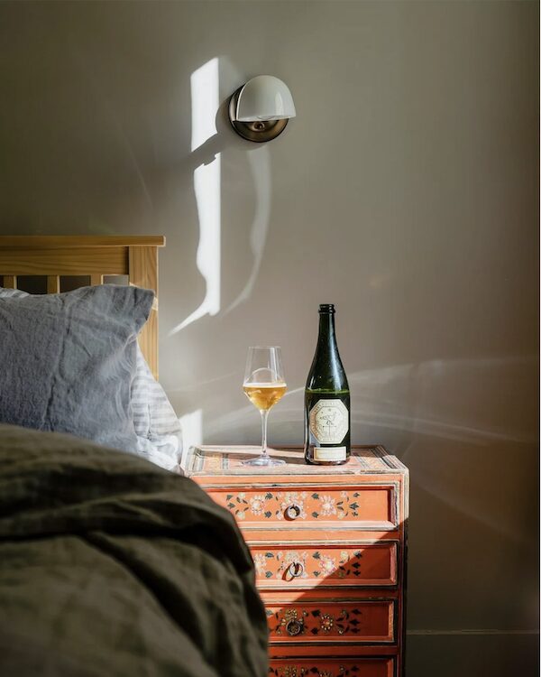 A glass and bottle of wine in the bedroom at Seminary Hill in Hudson NY.