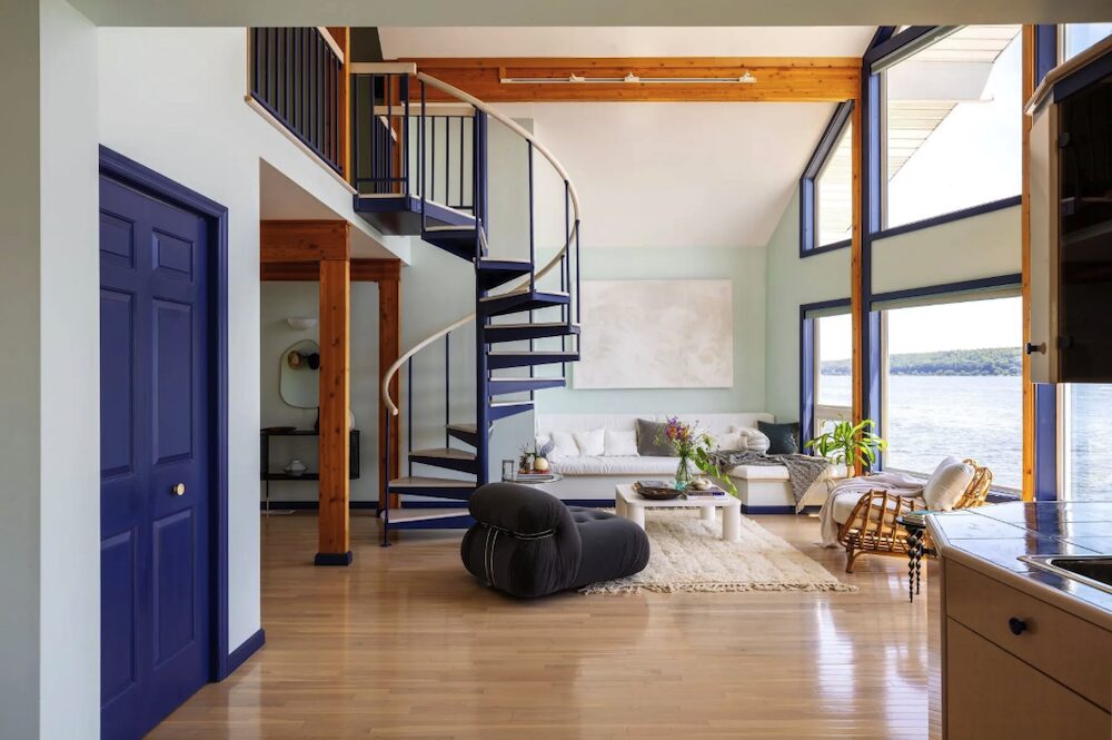 Open living space with spiral ctairs at 63 River Road, Malden NY.