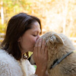 Lisa Bonk of Grateful Pups Training kissing her dog T.