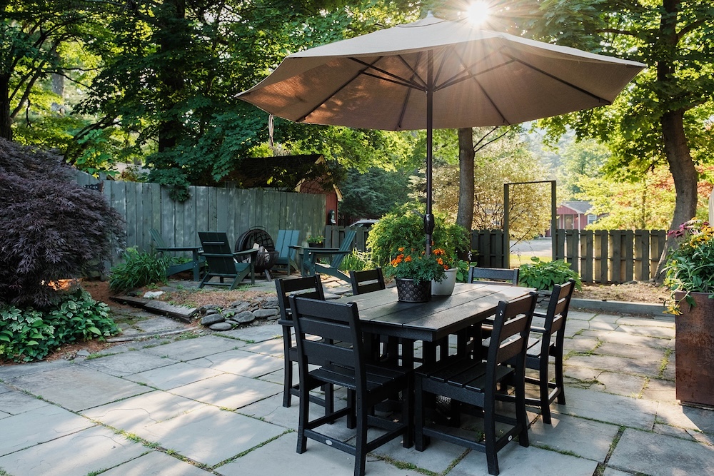 outside table, umbrella and fire pit at Phoenicia Lodge in the Catskills.