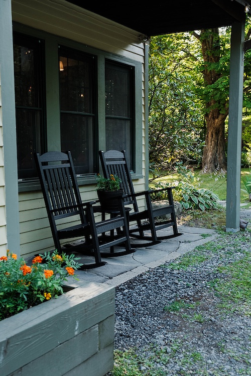 the black rocking chairs outside of the cabins at Phoenicia Lodge in the Catskills.
