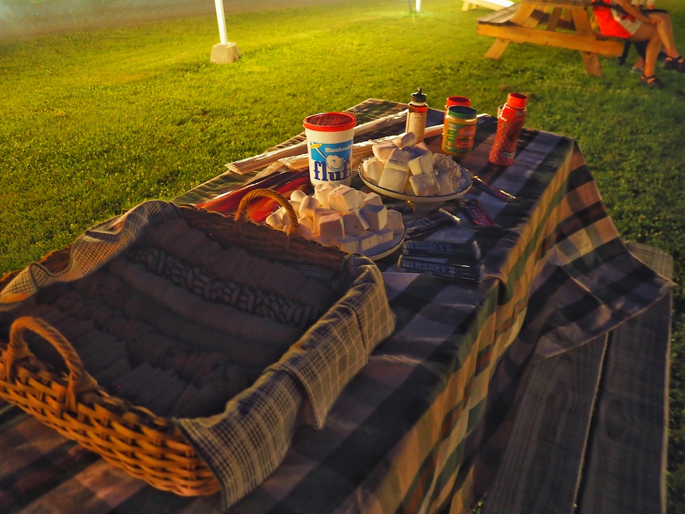 Picnic table filled with treats for making s'mores at Hi-Way Drive-In Theater in Coxsackie NY.