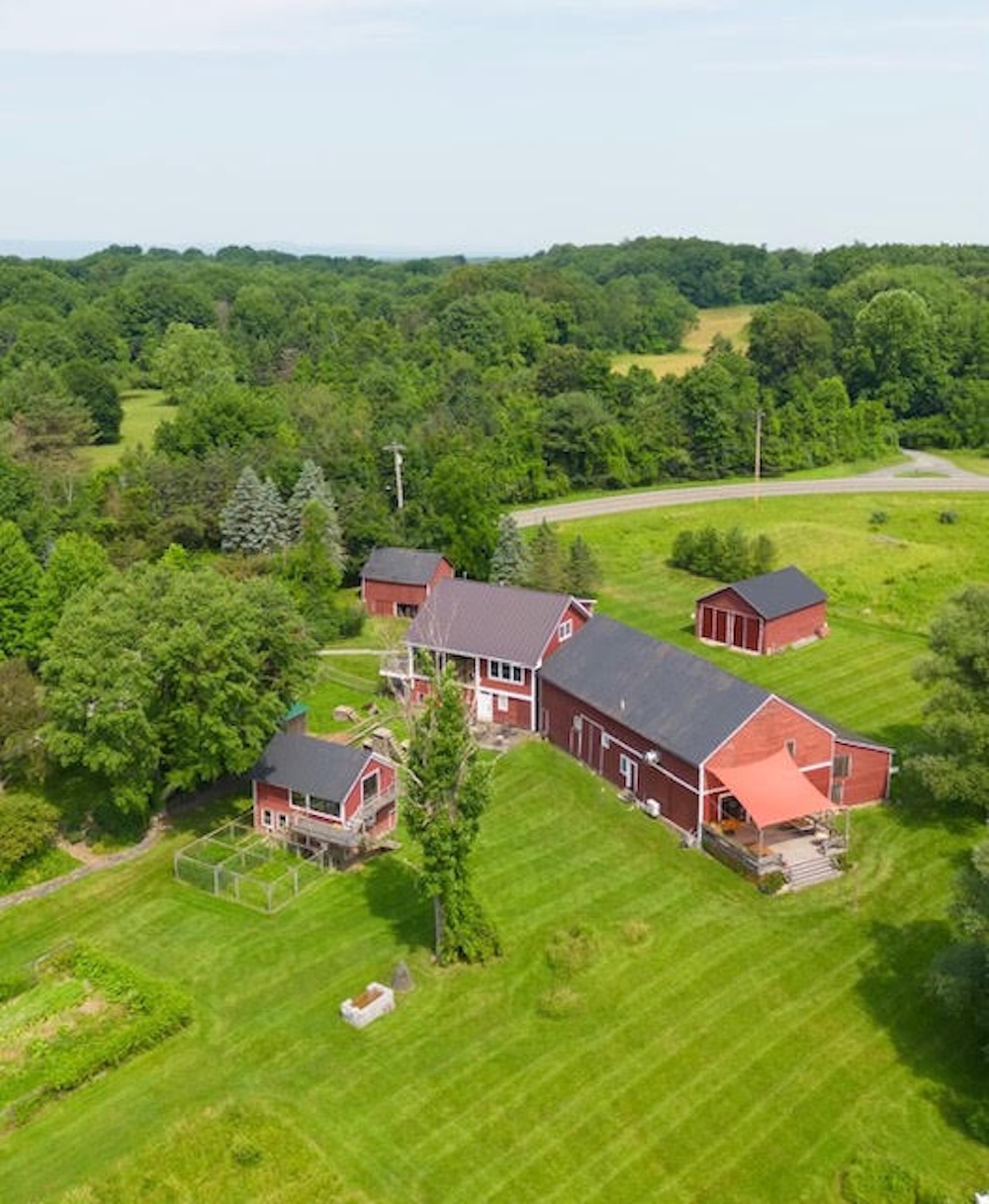 Red barns out in field aerial view